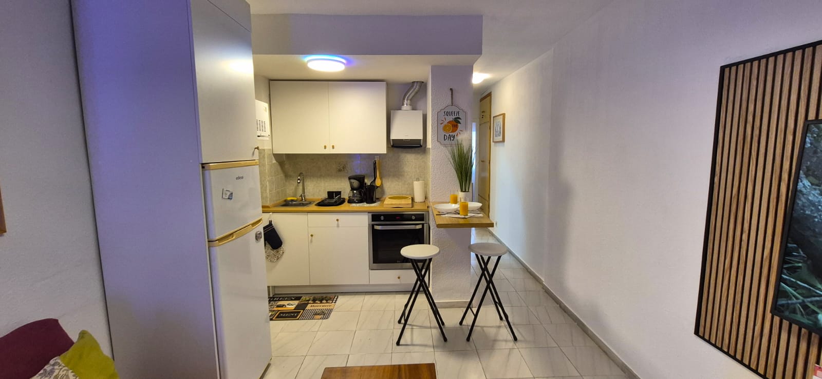 Kitchen with breakfast bar and two stools