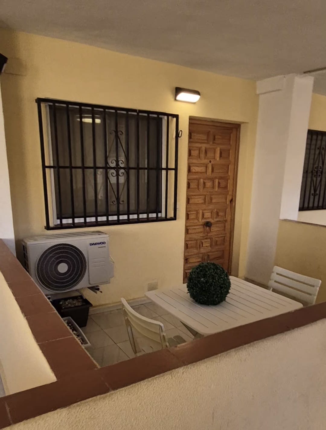 Private terrace with table and chairs at the apartment entrance